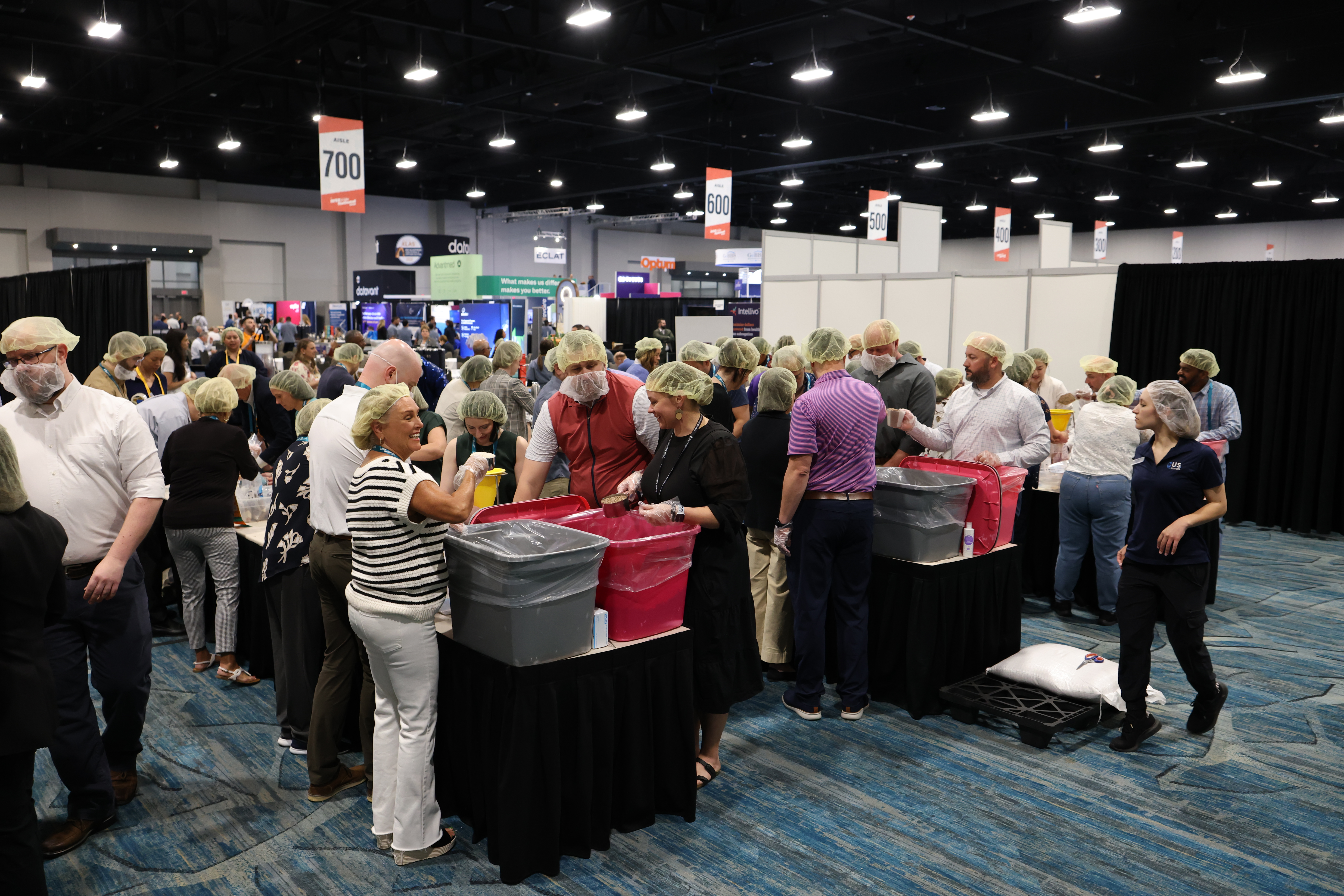 Group of attendees at a roundtable session in the exhibit hall